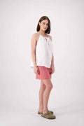1. Main shot: "Cambrian linen top in white, relaxed halter neck with gathered front detail, styled with coral linen skirt, handmade by Lohi Linen in Central Otago, New Zealand"