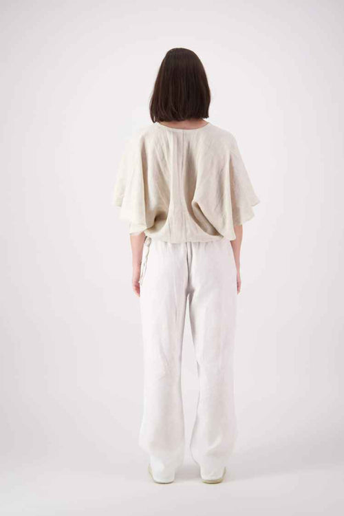 Back view: "Paerau linen top back view showing wide flutter sleeves and drawstring hem, handmade by Lohi Linen in Ranfurly, New Zealand"