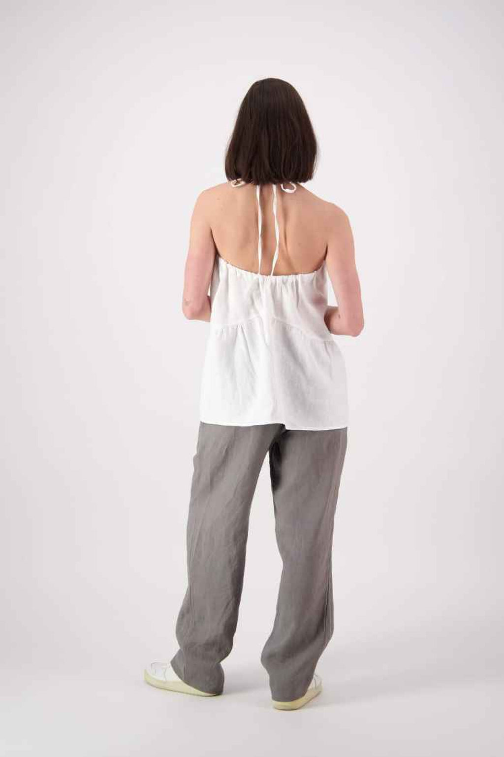 Back view grey pants: "Ranfurly linen top in white back view styled with grey linen pants, handmade by Lohi Linen in Central Otago, New Zealand"
