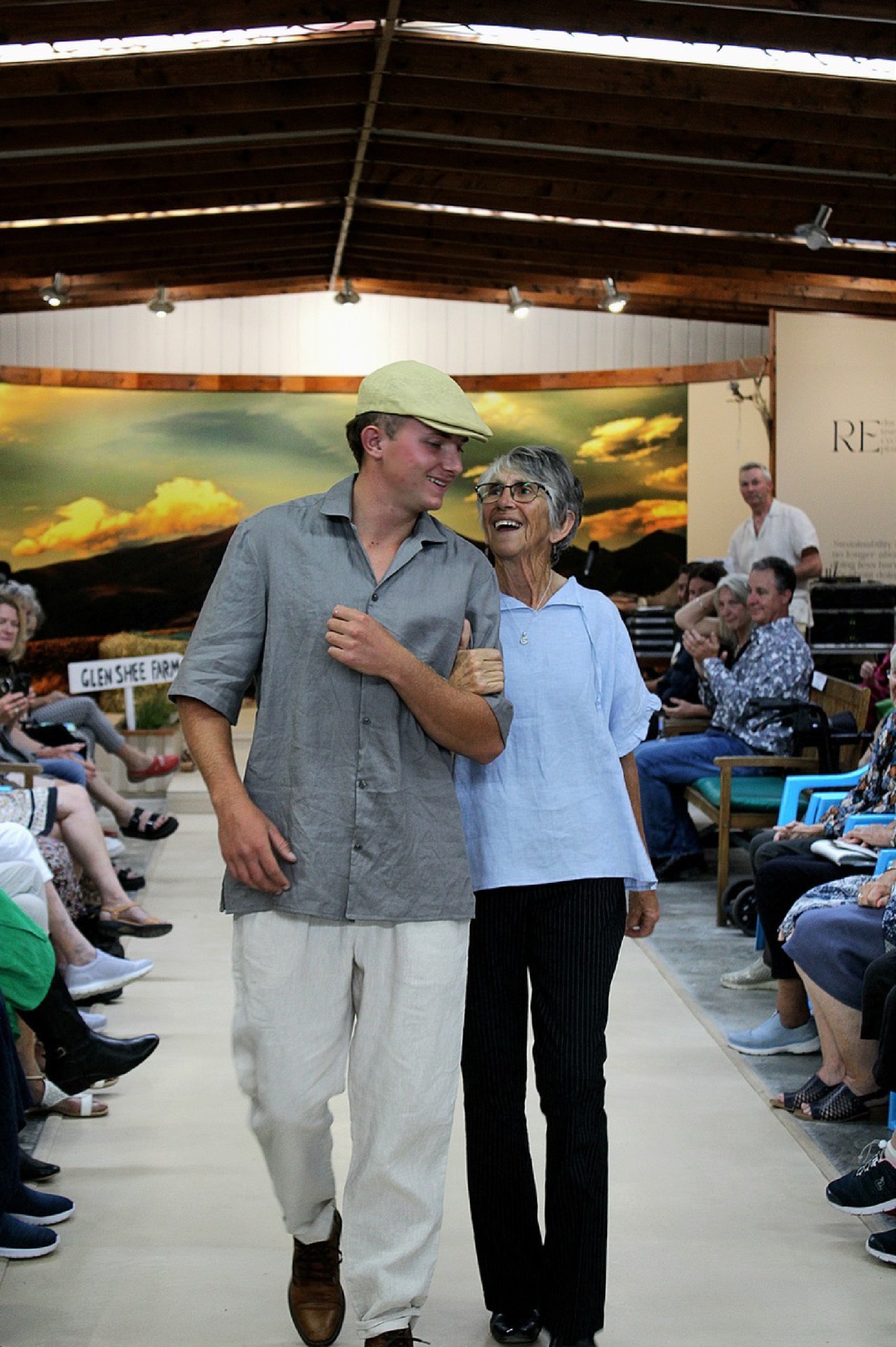 2. Two people wearing it: "Patearoa men's linen shirt in natural oat worn outdoors, relaxed camp collar style, handmade by Lohi Linen in Ranfurly, New Zealand"