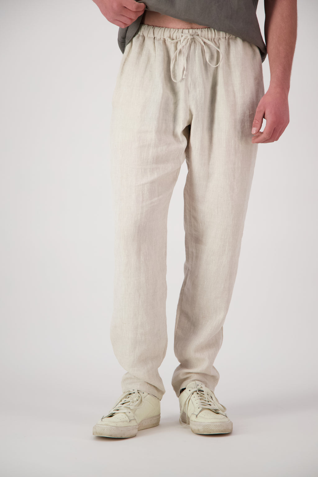 Detail shot legs natural: "Mt Buster linen pants mens in Natural close up showing drawstring waist and relaxed leg, handmade by Lohi Linen"