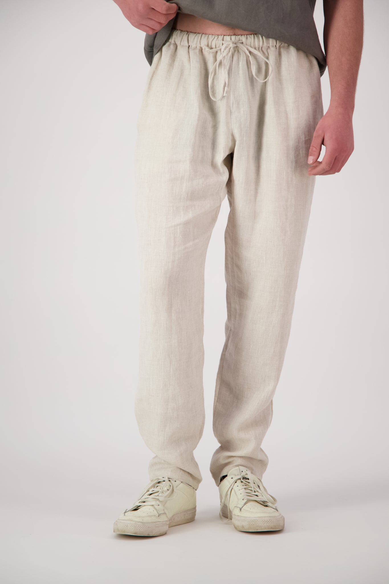 Detail shot legs natural: "Mt Buster linen pants mens in Natural close up showing drawstring waist and relaxed leg, handmade by Lohi Linen"