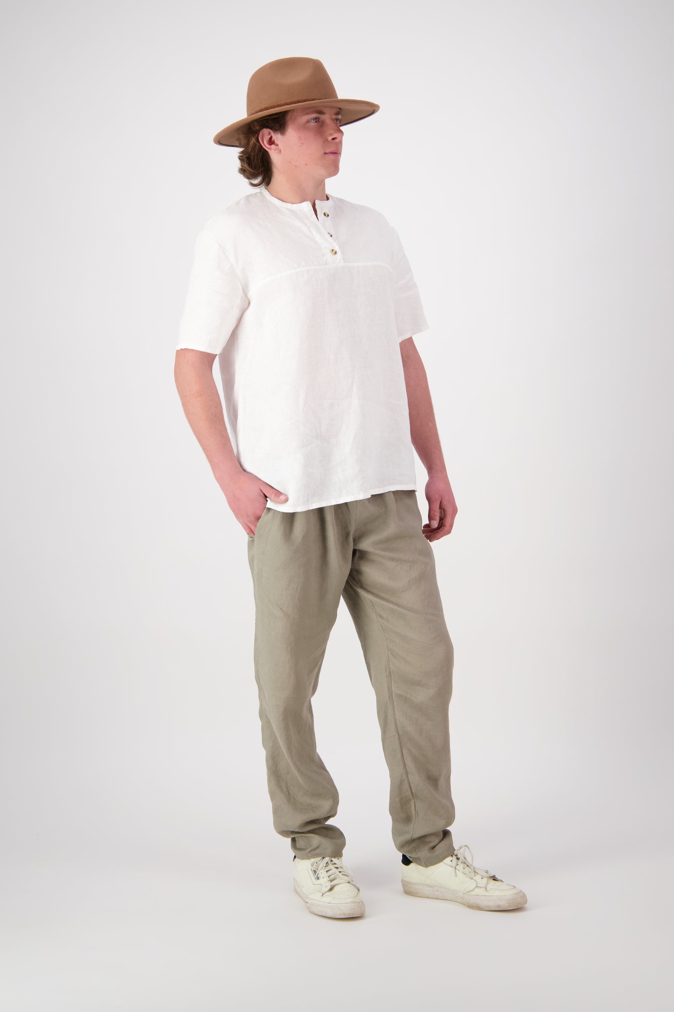 Side view: "Hawkdun linen top in White side view showing relaxed fit and henley neckline, handmade by Lohi Linen Central Otago"
