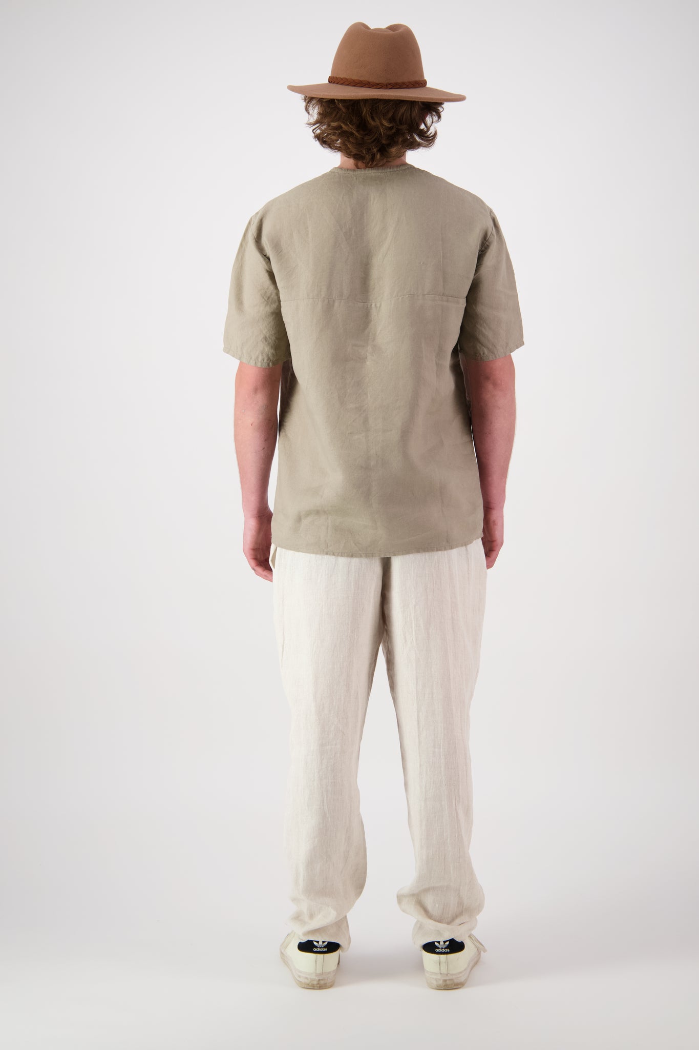 Back view: "Hawkdun linen top in stone back view, relaxed short sleeve, handmade by Lohi Linen in Central Otago, New Zealand"