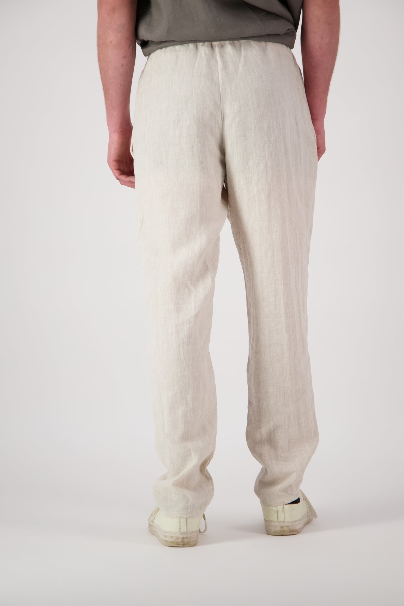 Detail shot legs natural: "Mt Buster linen pants mens in Natural close up showing drawstring waist and relaxed leg, handmade by Lohi Linen"