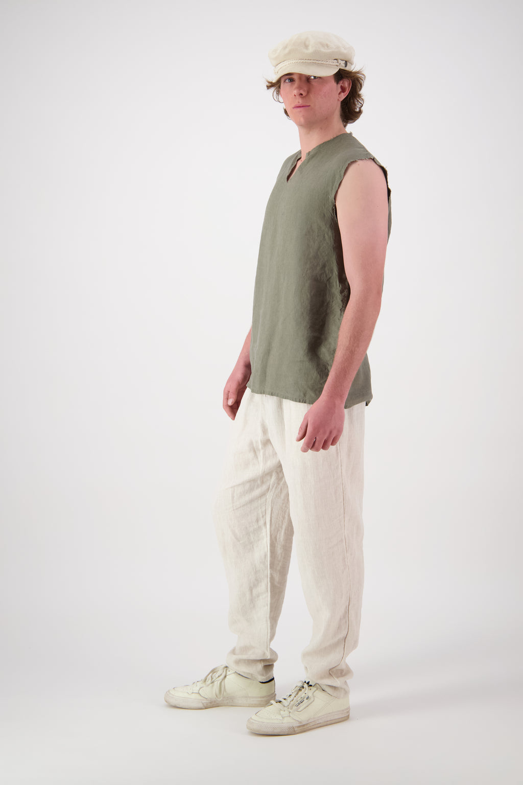 Front view full length: "Rough Ridge linen singlet in olive green full length front view with natural linen pants, handmade by Lohi Linen Central Otago"
