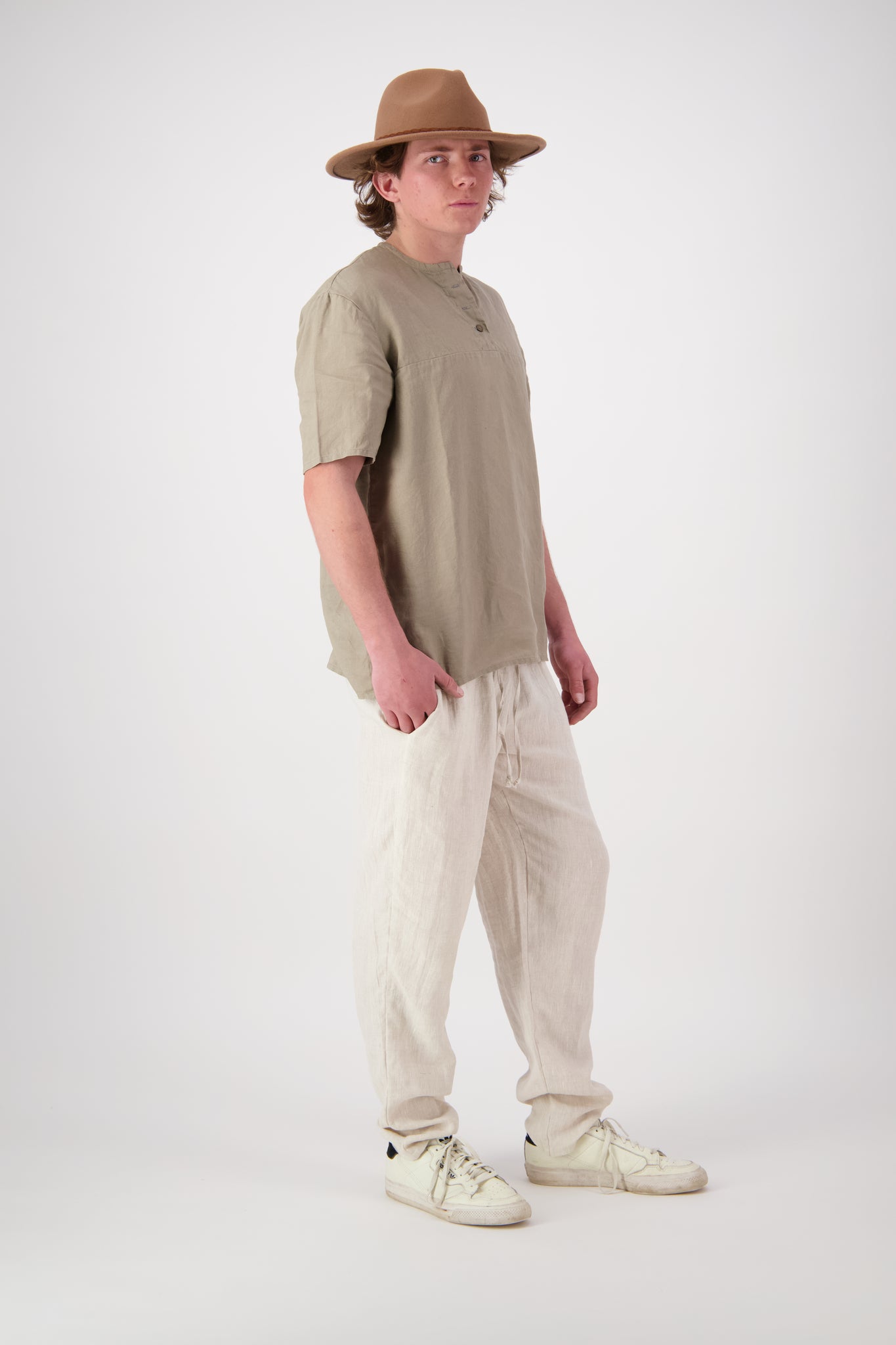 Three quarter view: "Hawkdun linen top in stone three quarter view showing relaxed silhouette, handmade by Lohi Linen Ranfurly"