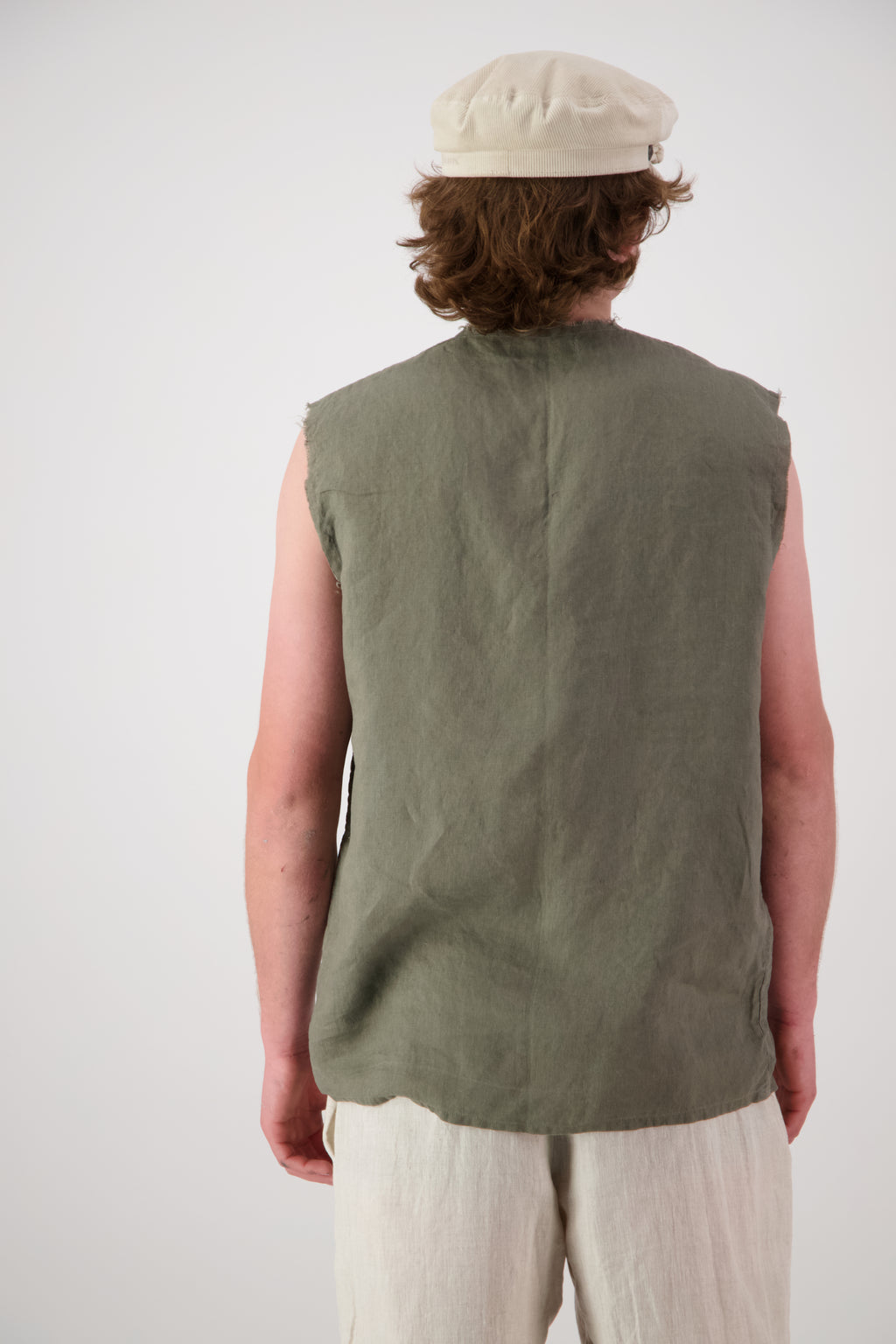 Back view: "Rough Ridge linen singlet in olive green back view showing relaxed sleeveless cut, handmade by Lohi Linen in Central Otago