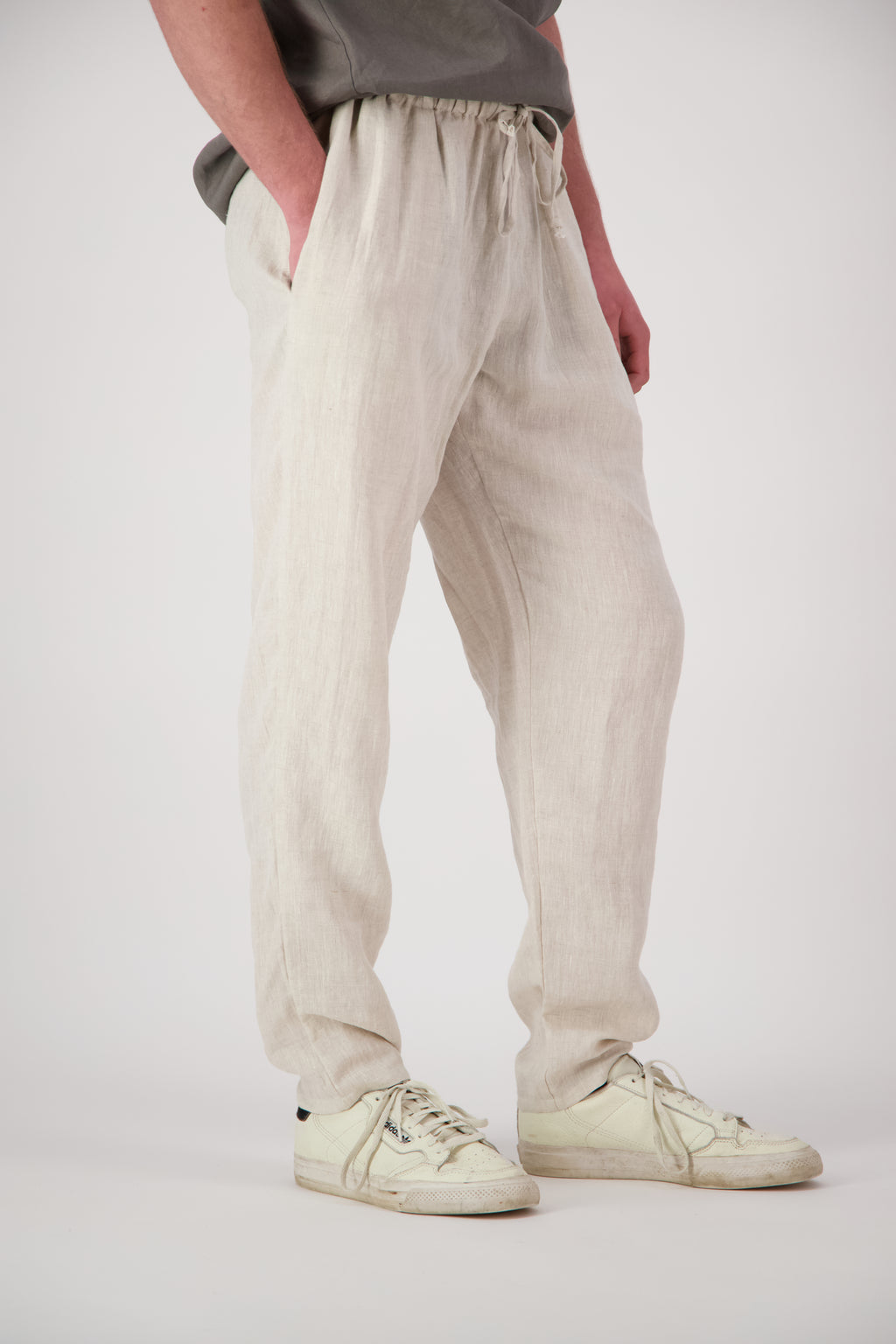 Detail shot legs antique pearl: "Mt Buster linen pants mens in Natural leg detail showing relaxed straight cut and natural linen texture, Lohi Linen Central Otago"