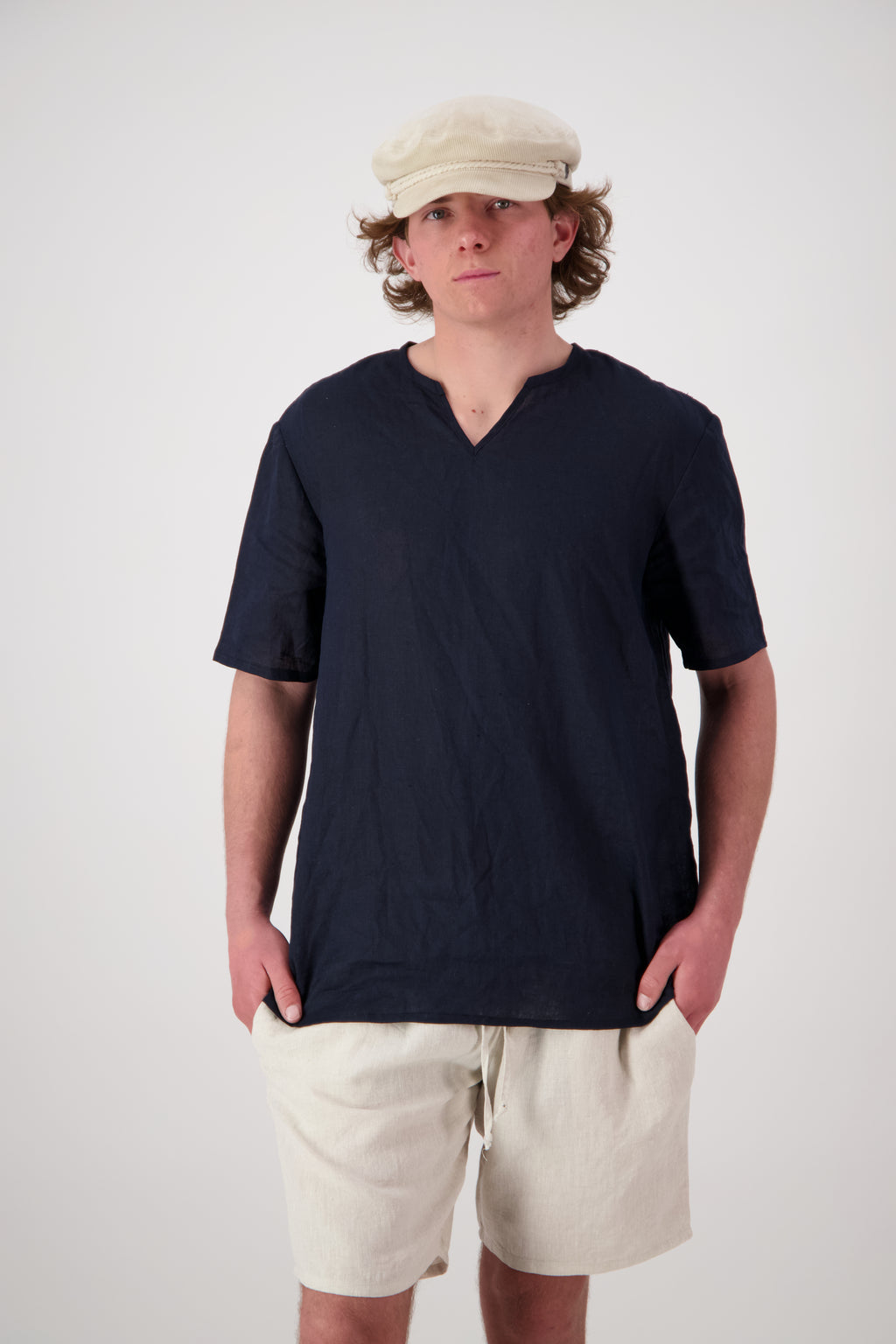 Main shot (midnight): "St Bathans linen t-shirt in midnight navy, relaxed notch neckline short sleeve, worn with natural linen shorts, handmade by Lohi Linen in Central Otago, New Zealand"